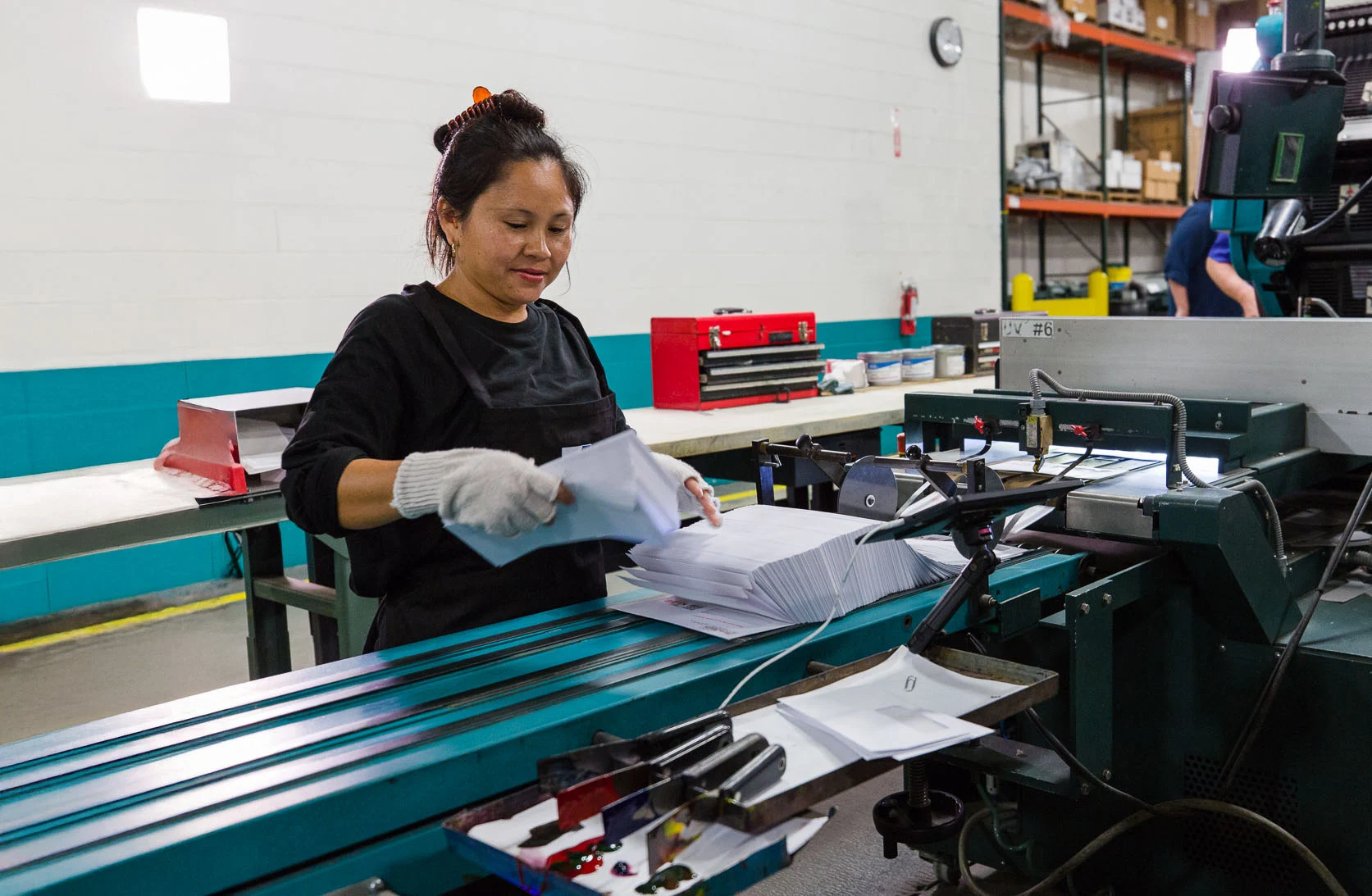 Worker Working an Envelope Printer