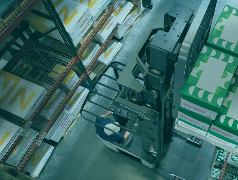 Worker Using Forklift for Paper